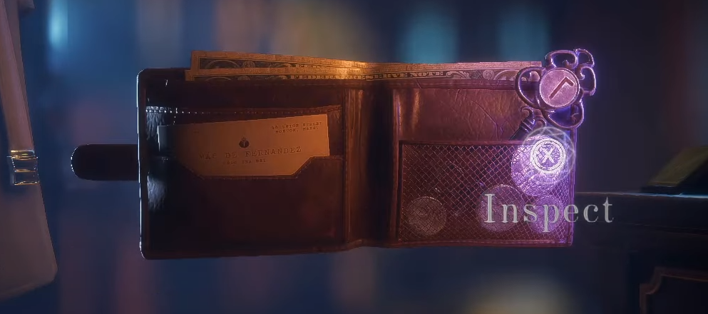 A wallet being inspected, revealing a hidden key inside