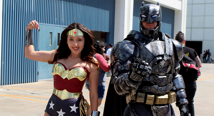 Two cosplayers dressed as Wonder Woman and Batman at a convention